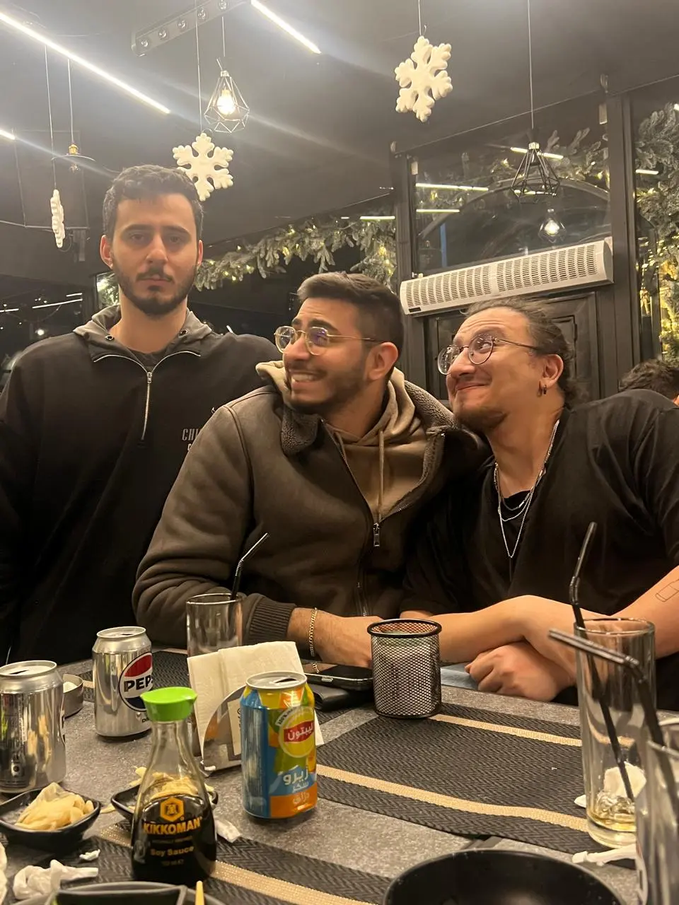 Three friends leaning in for a photo